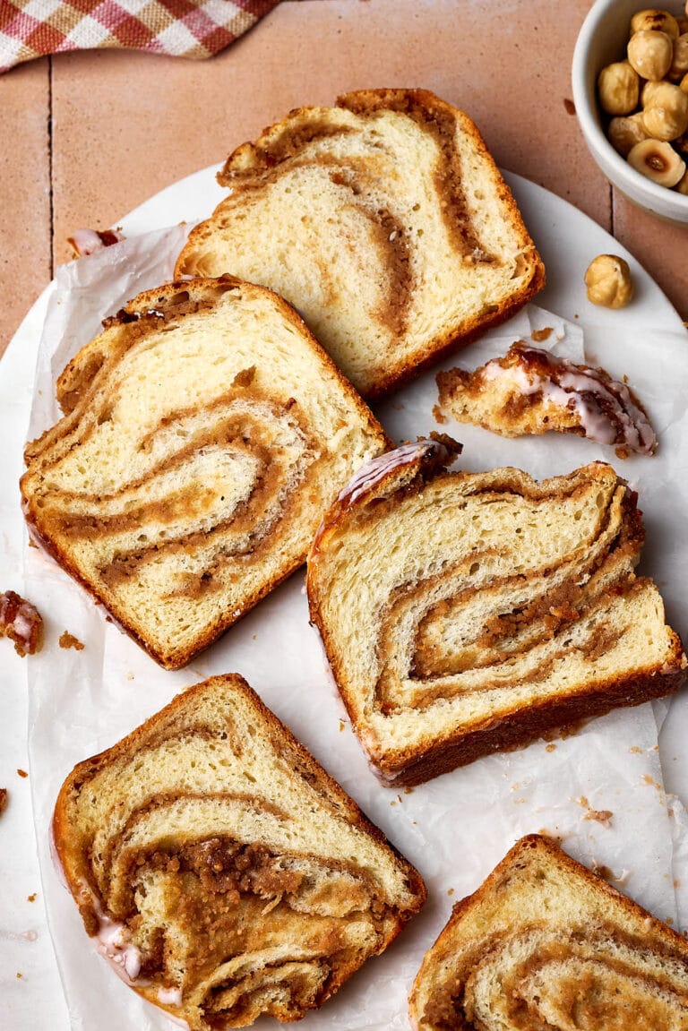 Saftiger Nusszopf in Scheiben geschnitten auf einem Marmortablett.